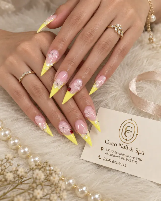 Yellow floral stiletto nails with pearl details